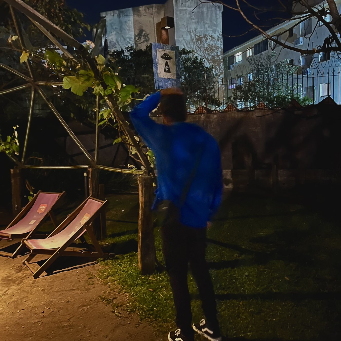 Yunguer in a blue hoodie under a tree at night