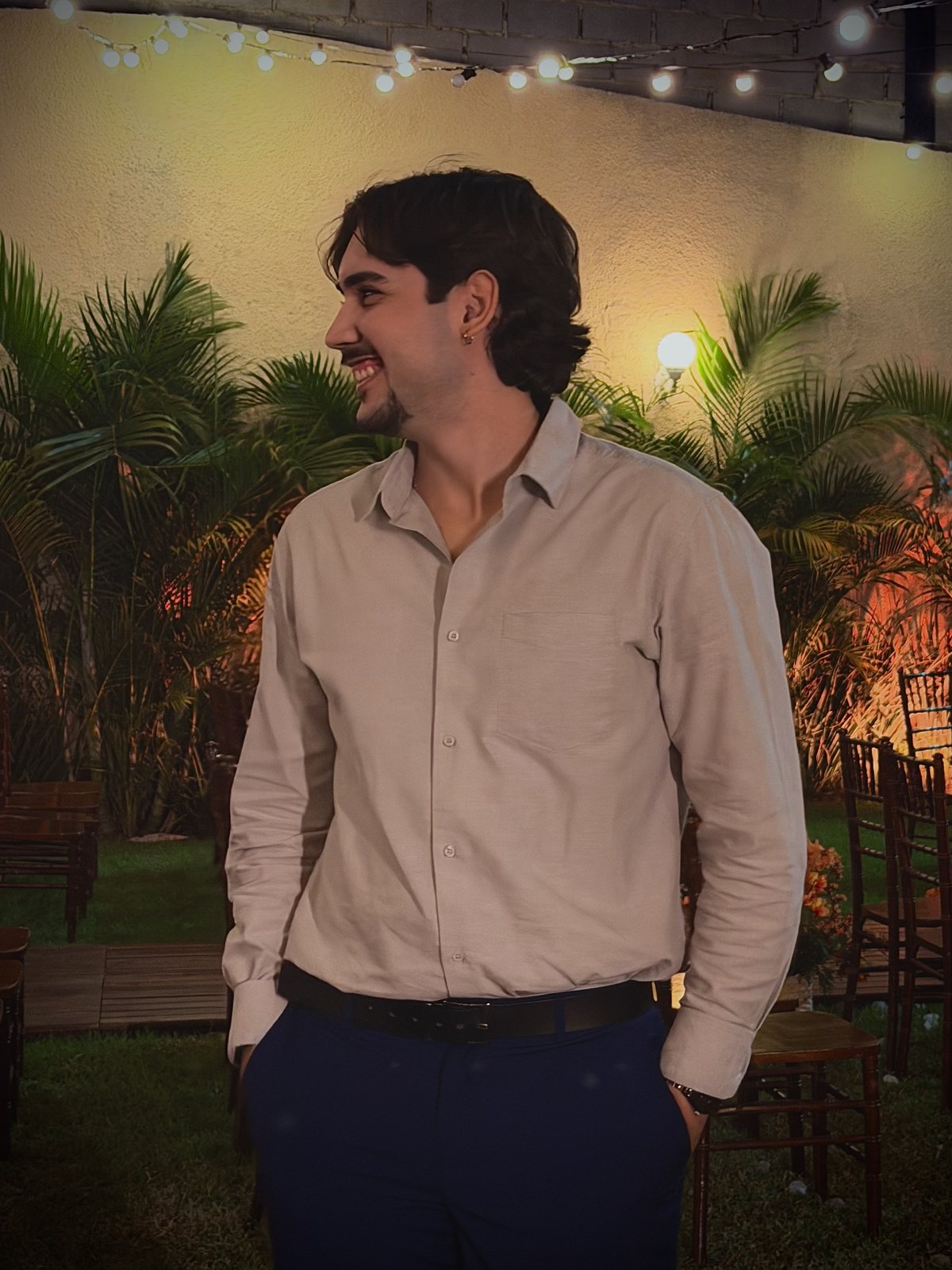 Yunguer in a light shirt among palm trees